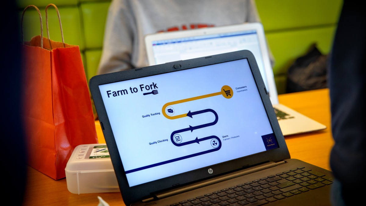 An open laptop with a graphic on it that says farm to fork