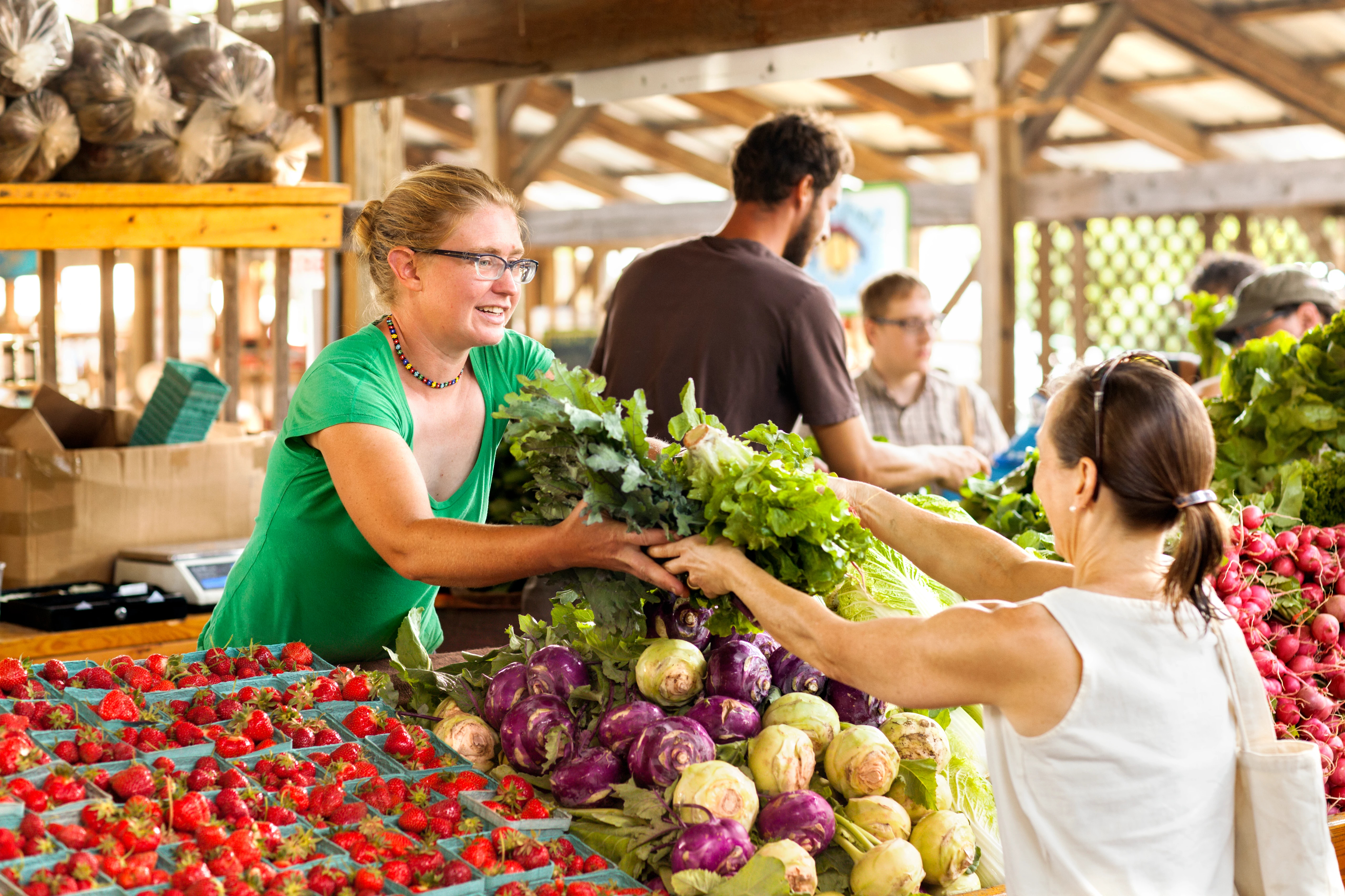 Woman purchasing produce at farmers market
