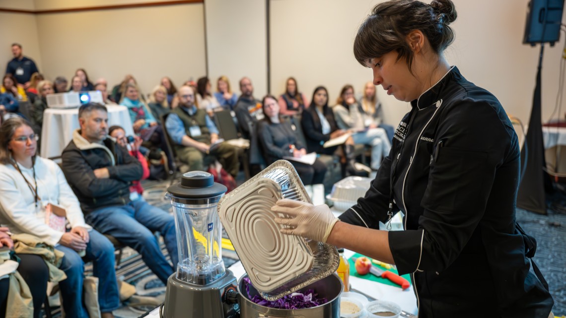 Attendees watch a food preparation presentation at the inaugural New York Farm to School Summit in Syracuse, N.Y.