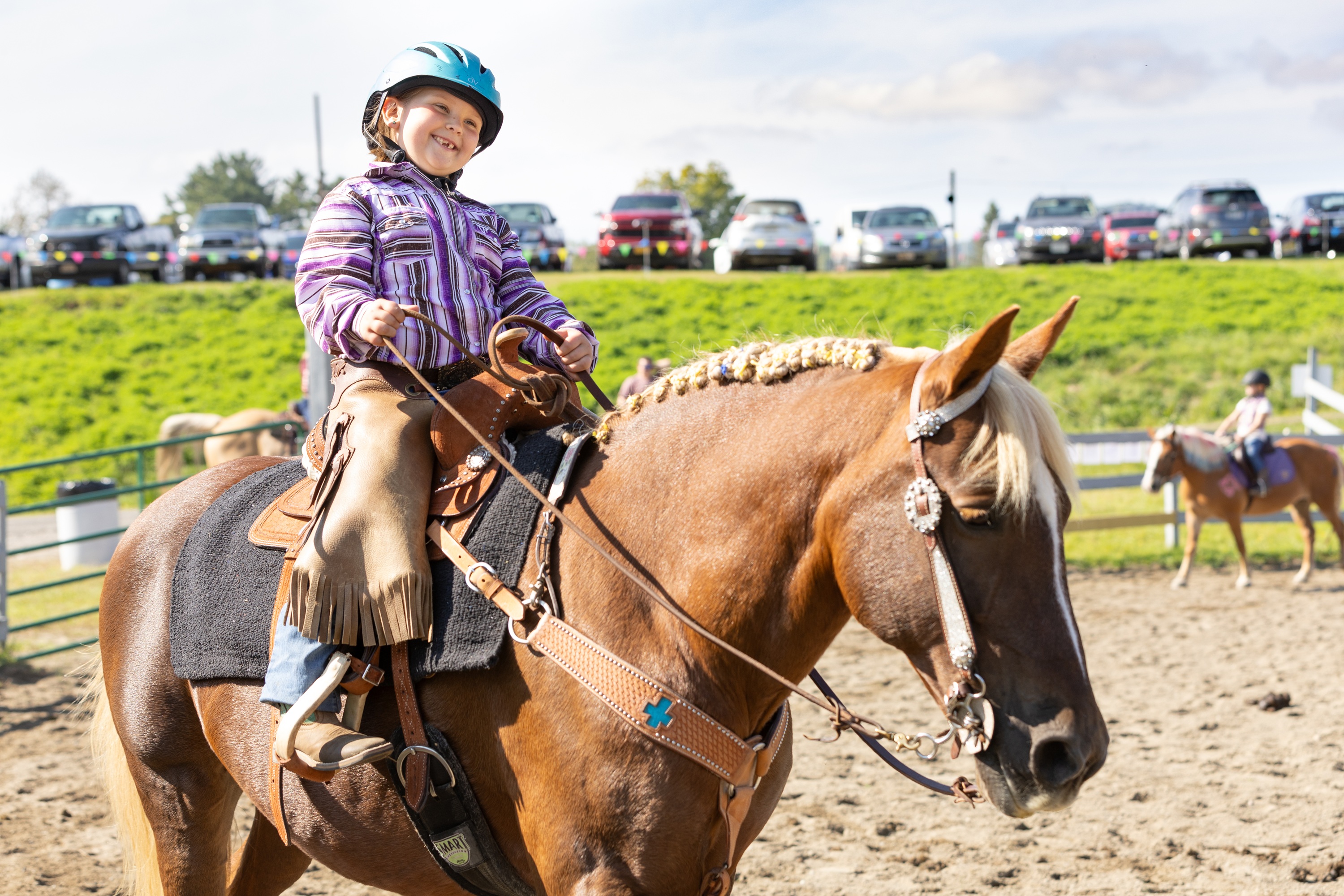 A young girl rides a horse