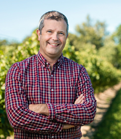 Hans Walter-Peterson standing in a vineyard