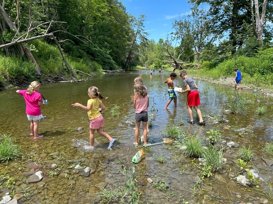 Children playing in a creek