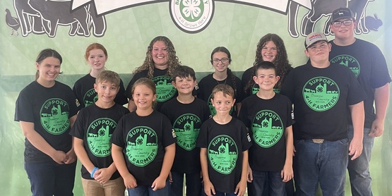 a group of 4-H'ers posing at the Livestock Auction
