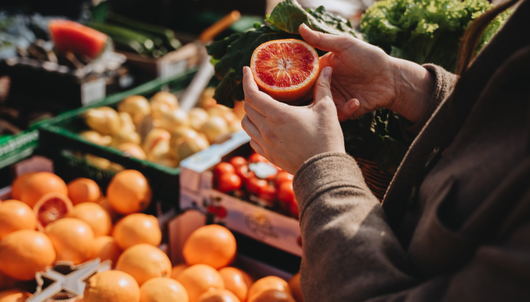 hands holding half an orange