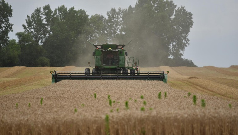 A man operating a hay bailer 