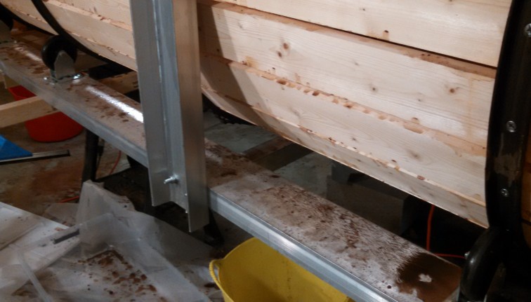 The outside metal frame of a root barrel washer with food debris on it.