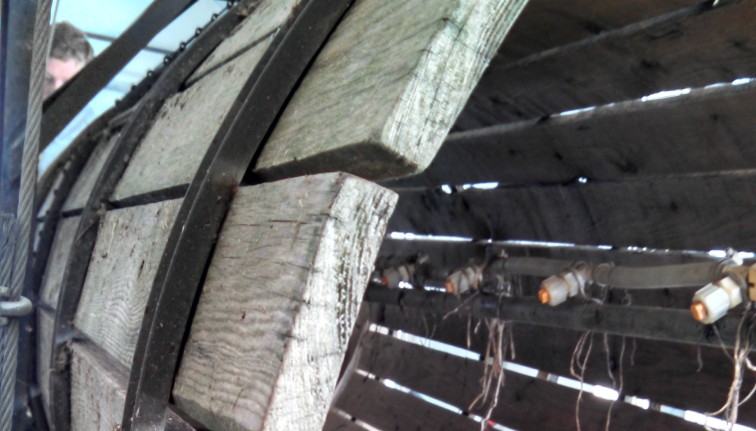 Wooden staves of a root barrel washer look weathered and dirty.