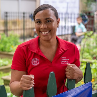 A smiling woman in a red polo shirt.
