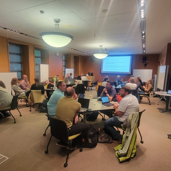 workshop participants working in groups at tables