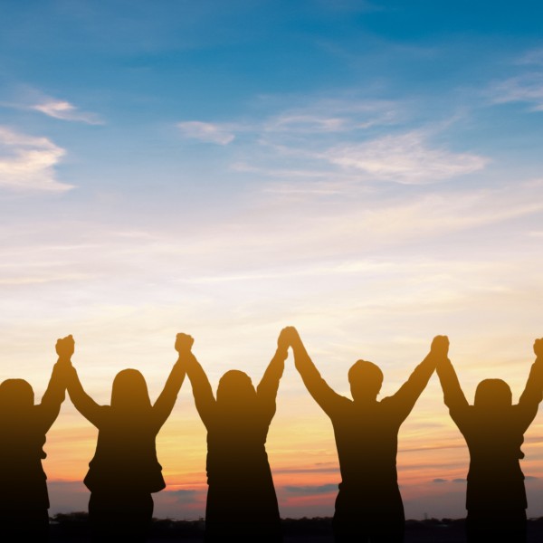 Silhouette of group happy business team making high hands over head in beautiful sunset sky evening time for business success and teamwork concept in 