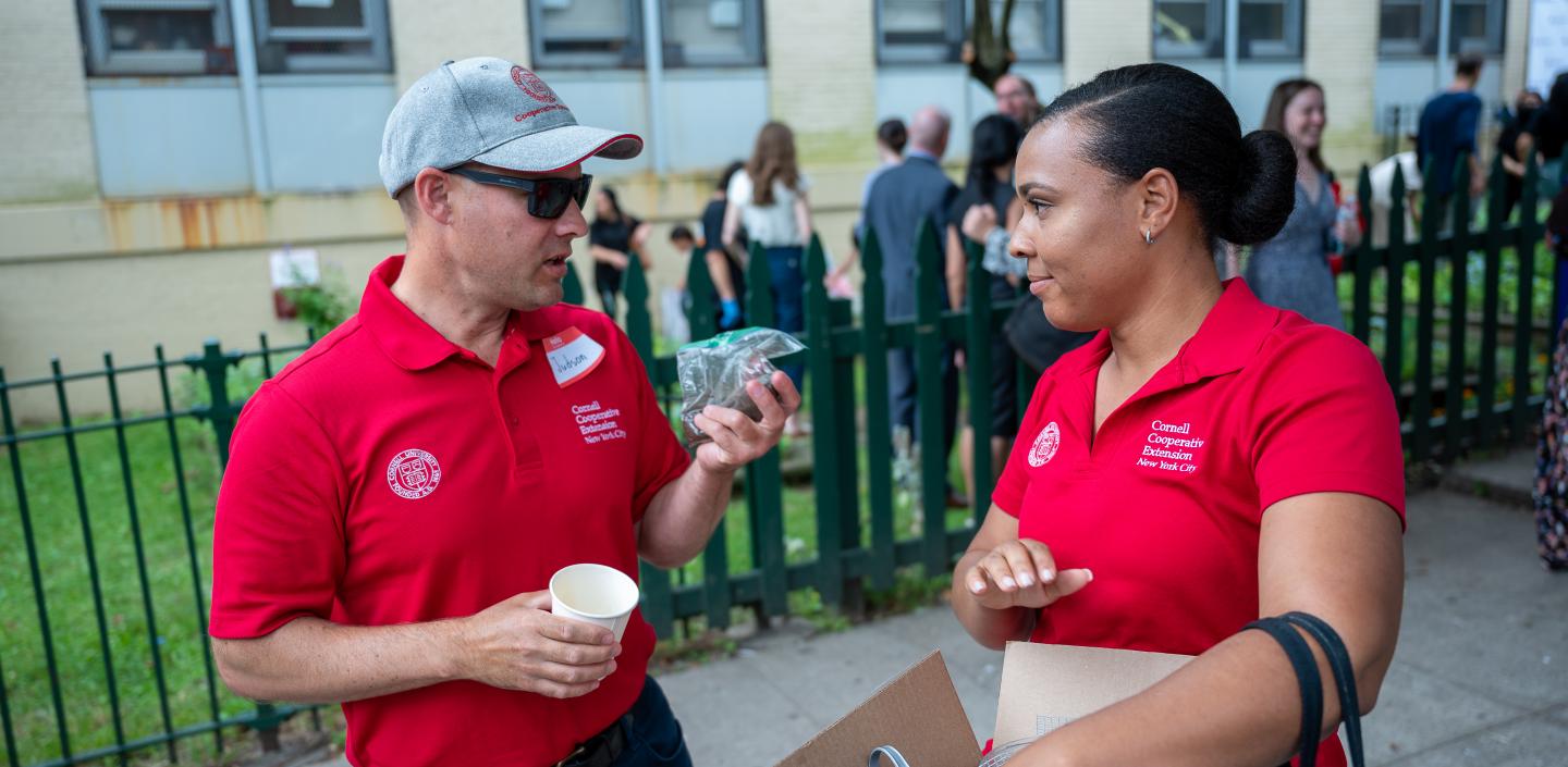Two people talk during a community garden event