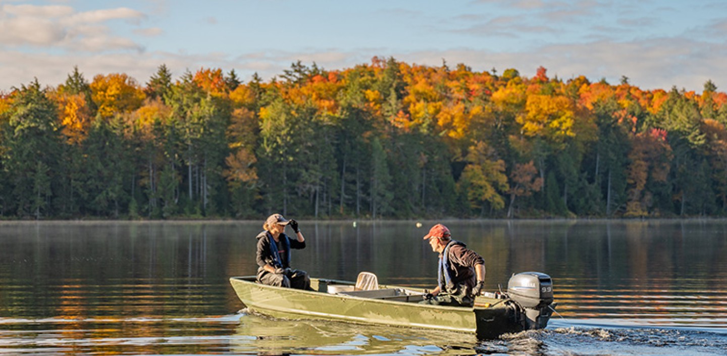 Two people fishing on a lake.