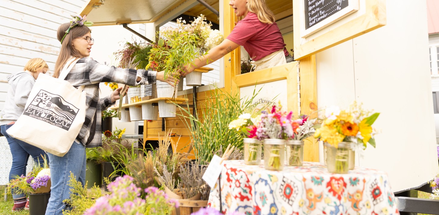 woman selling flowers to customer at festival