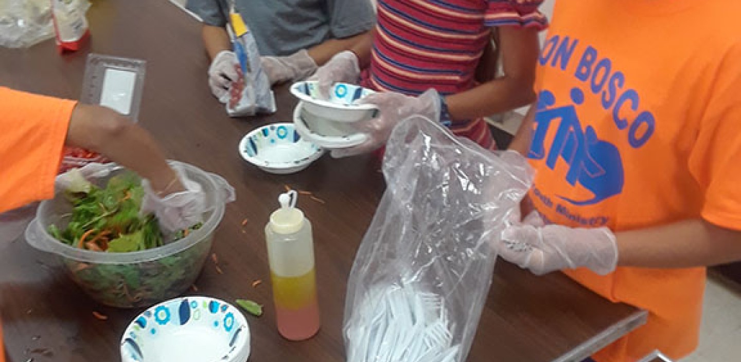 Nutrition staff teaching cooking at Don Bosco camp