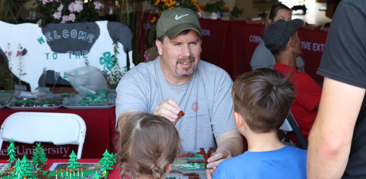 AWSMP Educator, Matt Savatgy, at the Ulster County Fair, Matt is showing them Legos from a handmade stream table.