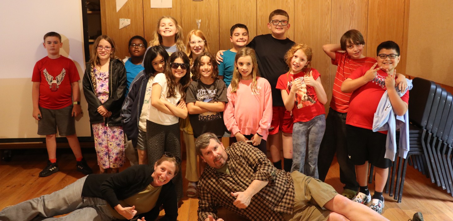 A group of students in the Watershed Detectives class smiling and posing for a group photo.