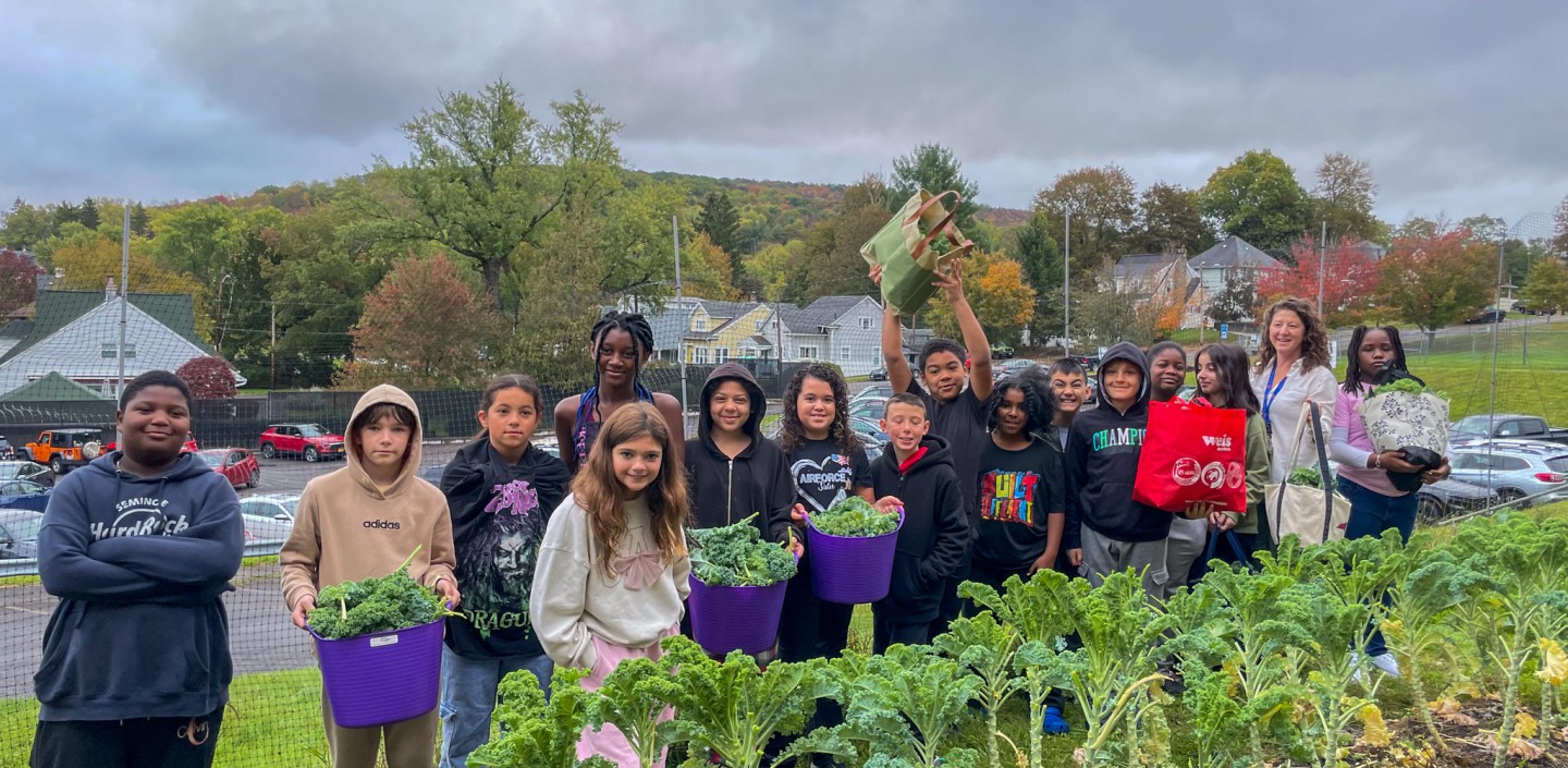 Ben Franklin students showing off their garden harvest