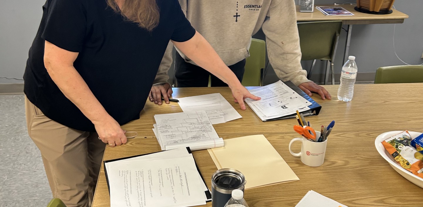 a man and woman looking a papers together