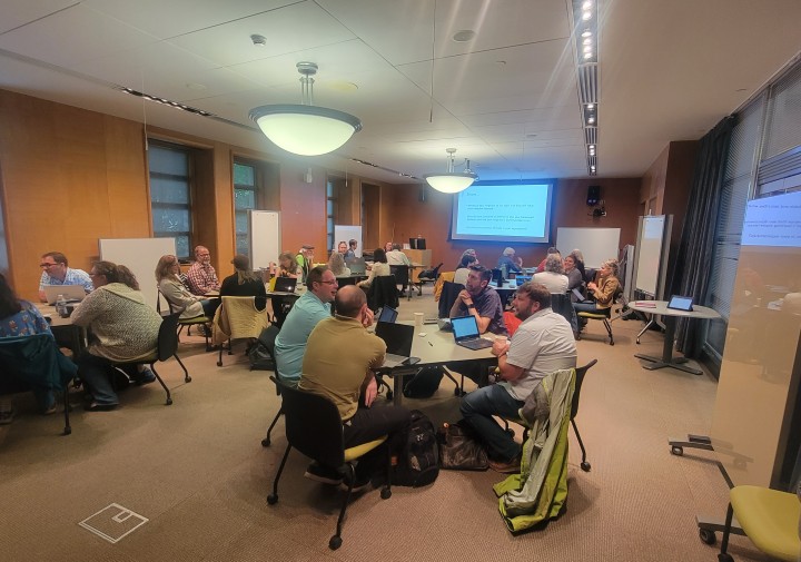 workshop participants working in groups at tables