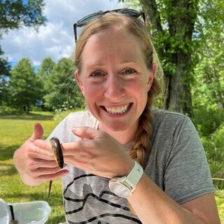 Anna Harrod-McGrew holding a small fish.