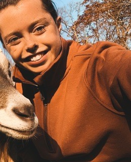 Picture of Faith Shultz with a goat