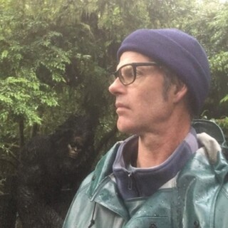 Picture of Michael Murphy in front of greenery