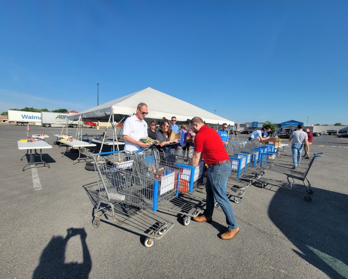 people sorting food at a food drive