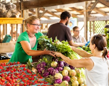Woman purchasing produce at farmers market