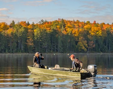 Two people fishing on a lake.