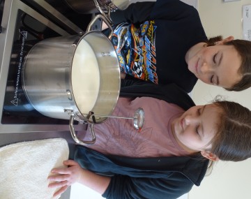 Two 4-H Youth participating in a cheese making workshop.