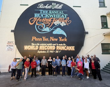 Group of people outside against a wall