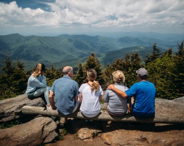 Family taking a break from hiking in the mountains.