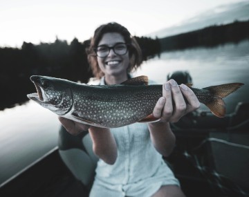 Woman holding a fish.