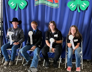 4 kids with prize ribbons at state fair
