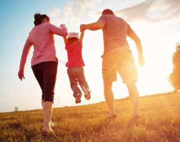 parents holding up their kid