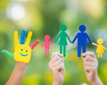 a painted hand and cut outs of people held up on sticks