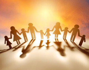 paper cut outs of people standing hand in hand