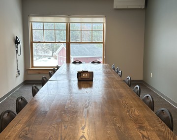 long table with chairs around it in a conference roome