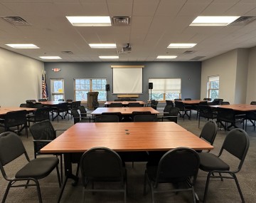 conference room set up with tables and chairs