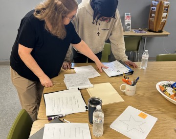a man and woman looking a papers together